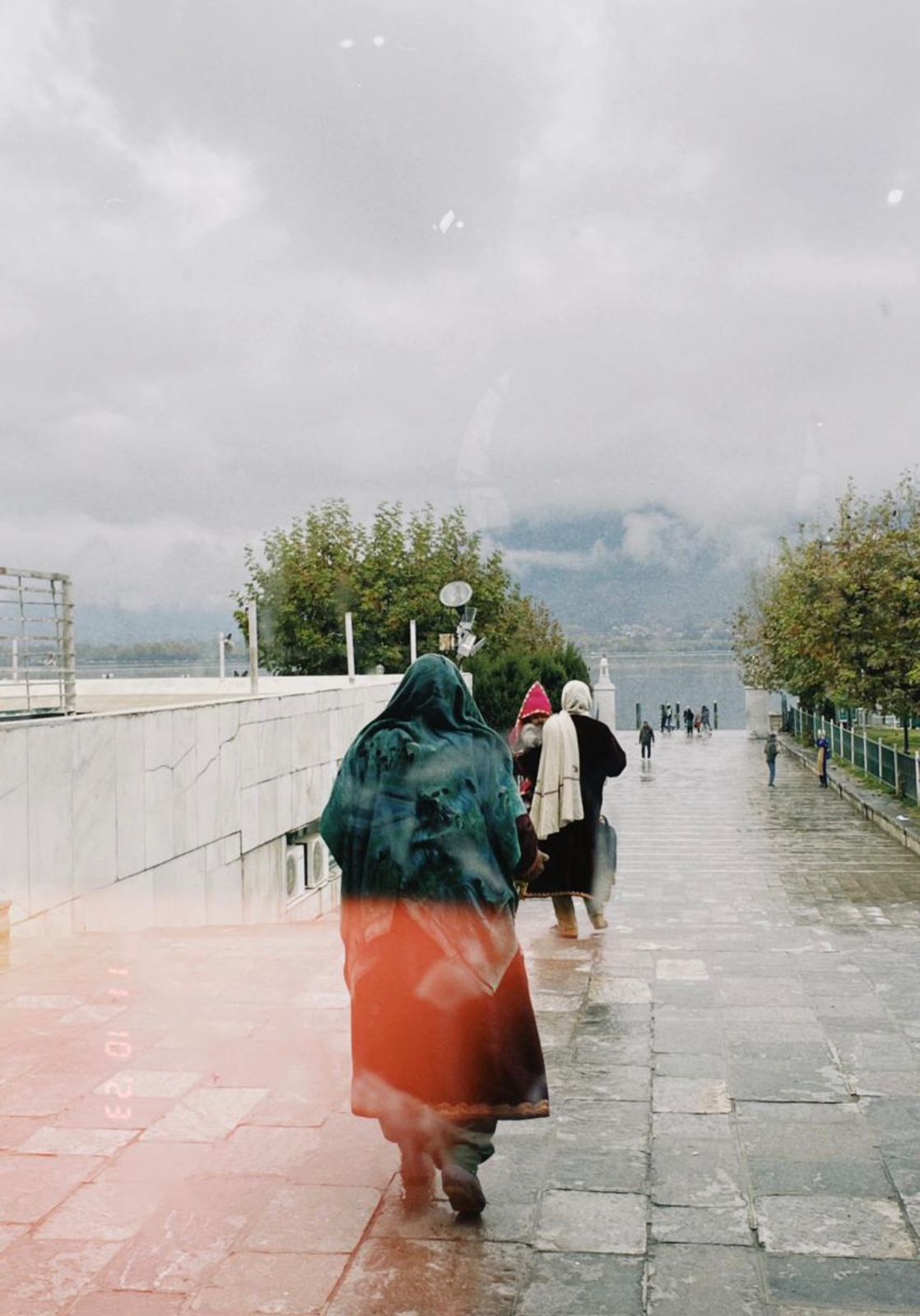 Three generations of women walking out of a mosque in Kashmir.