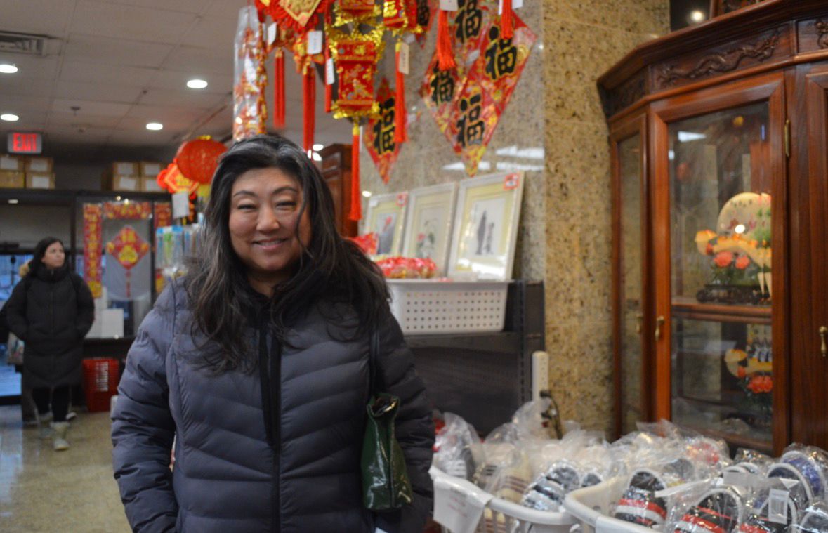 Suzi Robinson in Boston’s Chinatown curating cards for the Chinese New Year.